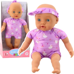 Muñeca bebé de tela con body morado y diadema con lazo 31 cm