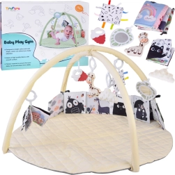 Manta de juego educativa con arcos y juguetes colgantes