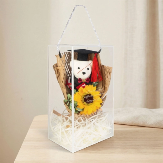 Decoración artificial con girasol y oso de graduación