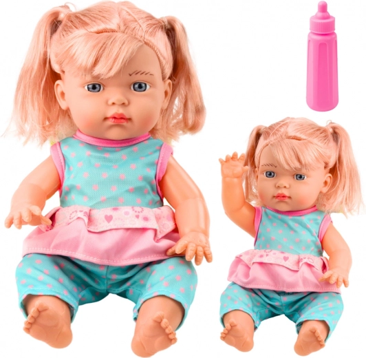Muñeca bebé en conjunto turquesa con biberón y sonidos