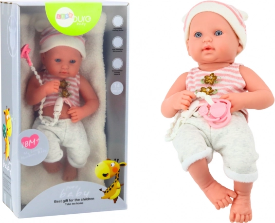 Muñeca bebé con conjunto blanco‑rosa, chupete y gorrito