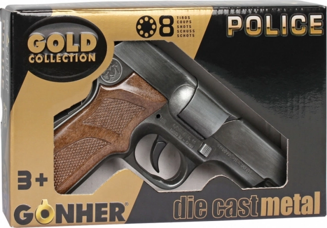 Pistola policial metálica de cápsulas Gold Collection