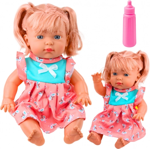 Muñeca bebé con vestido de colores, biberón y sonidos