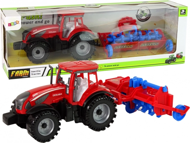 Tractor rojo con arado con tracción por fricción