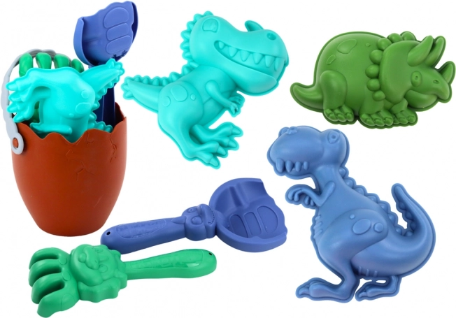 Set de arena de dinosaurios con cubo en forma de huevo, pala, rastrillo y moldes