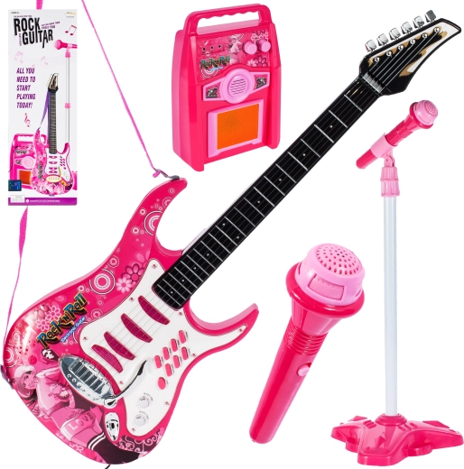Guitarra rosa con amplificador y micrófono