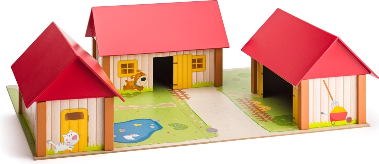 Granja de madera con tres edificios y tapete de juego
