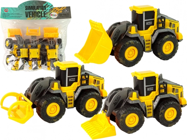 Juego de tres vehículos de construcción amarillos